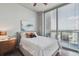 Bright bedroom featuring floor-to-ceiling windows and a balcony with city views at 777 N Ashley Dr # 2603, Tampa, FL 33602