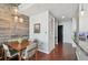 Cozy dining area with rustic wood accent wall, modern lighting, and hardwood floors creating an inviting space at 777 N Ashley Dr # 2603, Tampa, FL 33602