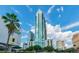 Stunning high-rise building with modern architectural design and a beautiful blue glass facade against a sunny sky at 777 N Ashley Dr # 2603, Tampa, FL 33602