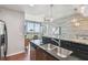 Open concept kitchen features stainless appliances, island sink, and hardwood floors at 777 N Ashley Dr # 2603, Tampa, FL 33602