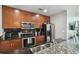 Inviting kitchen equipped with stainless steel appliances, dark backsplash, and granite countertops at 777 N Ashley Dr # 2603, Tampa, FL 33602