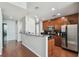 Modern kitchen featuring stainless steel appliances, granite countertops, wood cabinets, and hardwood floors, for cooking enjoyment at 777 N Ashley Dr # 2603, Tampa, FL 33602