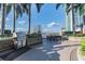 Outdoor kitchen area with grill and dining table on rooftop terrace with city views at 777 N Ashley Dr # 2603, Tampa, FL 33602