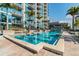 Condo pool with water feature, lounge seating, and building views at 777 N Ashley Dr # 2603, Tampa, FL 33602