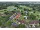 Aerial view of condo complex surrounded by mature trees and a golf course at 8005 Bardmoor Pl # 102I, Seminole, FL 33777