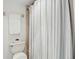 Bathroom with a shower featuring a neutral colored shower curtain and an adjacent toilet at 8005 Bardmoor Pl # 102I, Seminole, FL 33777