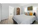 Bright bedroom with warm lighting, wood floors, and bookshelf storage at 8005 Bardmoor Pl # 102I, Seminole, FL 33777