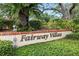 Fairway Villas community sign nestled amongst lush greenery at 8005 Bardmoor Pl # 102I, Seminole, FL 33777