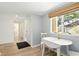 Bright breakfast nook with white table set by the window and hardwood floors at 8005 Bardmoor Pl # 102I, Seminole, FL 33777
