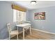 Cozy dining area with a white table, two chairs, and a window with natural light at 8005 Bardmoor Pl # 102I, Seminole, FL 33777