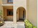 Inviting entryway with arched doorway, garden decor, and decorative tile at 8005 Bardmoor Pl # 102I, Seminole, FL 33777