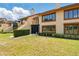 View of a condo with a manicured lawn, a porch, and beautiful windows at 8005 Bardmoor Pl # 102I, Seminole, FL 33777