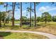 Scenic golf course view with lush green grass, mature trees and pond at 8005 Bardmoor Pl # 102I, Seminole, FL 33777