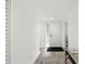 Bright hallway with wood-look floors, a glass block window, and neutral walls at 8005 Bardmoor Pl # 102I, Seminole, FL 33777