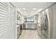 Modern kitchen featuring stainless steel appliances and sleek gray cabinetry at 8005 Bardmoor Pl # 102I, Seminole, FL 33777