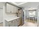 Contemporary kitchen with white countertops, stainless fridge, and adjacent breakfast nook at 8005 Bardmoor Pl # 102I, Seminole, FL 33777