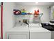 A laundry room featuring a washer, a dryer, and some storage at 8005 Bardmoor Pl # 102I, Seminole, FL 33777