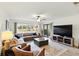 Spacious living room with a large sectional sofa, area rug, and sliding glass door to the backyard at 8005 Bardmoor Pl # 102I, Seminole, FL 33777