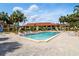 Community pool with lounge chairs, palm trees, and plenty of seating at 8005 Bardmoor Pl # 102I, Seminole, FL 33777