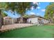 Well-maintained backyard with lush green lawn, privacy fence, shed and stone accents at 820 Hickory Ln, Palm Harbor, FL 34683