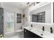 Modern bathroom boasts a double vanity, illuminated mirror, and stylish black and white accents at 820 Hickory Ln, Palm Harbor, FL 34683