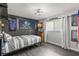 Bright bedroom featuring modern furnishings and a grey brick accent wall at 820 Hickory Ln, Palm Harbor, FL 34683