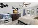 Bright bedroom with a ceiling fan, a dresser with a TV on it, and a sliding door to the outside at 820 Hickory Ln, Palm Harbor, FL 34683