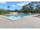 Large community pool with ample lounge chairs, perfect for relaxing and enjoying the outdoors at 820 Hickory Ln, Palm Harbor, FL 34683