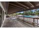 Covered veranda overlooking the pool with tables, chairs, and comfortable seating, perfect for relaxation at 820 Hickory Ln, Palm Harbor, FL 34683