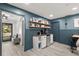 Dining area with wooden table and chairs and a minibar with light grey cabinets and shelves at 820 Hickory Ln, Palm Harbor, FL 34683