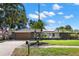 Charming single-story home boasts a well-maintained lawn, palm trees, and a neutral color scheme at 820 Hickory Ln, Palm Harbor, FL 34683