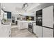 Well-lit kitchen featuring stainless steel appliances and an open floor plan with a view to the living area at 820 Hickory Ln, Palm Harbor, FL 34683