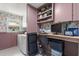 The laundry room doubles as a home office with a modern computer and built-in shelving at 820 Hickory Ln, Palm Harbor, FL 34683