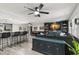 Spacious living room boasts modern lighting, stylish decor, an open floor plan, and bar seating at 820 Hickory Ln, Palm Harbor, FL 34683