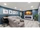 Comfortable living room featuring a modern fireplace, large TV, and cozy seating at 820 Hickory Ln, Palm Harbor, FL 34683