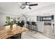 Open-concept living space with a bar, a dining area with a unique wood table, and a relaxing seating area at 820 Hickory Ln, Palm Harbor, FL 34683