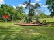 Community playground with slides and climbing structures set in a grassy park-like setting at 820 Hickory Ln, Palm Harbor, FL 34683