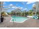 A backyard pool and lanai offer a private oasis for relaxation and recreation at 820 Hickory Ln, Palm Harbor, FL 34683