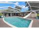 Screened-in pool with slide, outdoor seating, and a spacious lounging area perfect for entertaining at 820 Hickory Ln, Palm Harbor, FL 34683