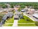 Aerial view of a home with lush lawn and mature landscaping in a suburban neighborhood at 908 Stallion Way, Valrico, FL 33594