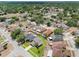 A quiet neighborhood showcases lush trees and manicured lawns, highlighting community charm at 908 Stallion Way, Valrico, FL 33594