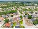 High-angle shot of a suburban home with a tidy backyard and green lawn surrounded by other houses at 908 Stallion Way, Valrico, FL 33594