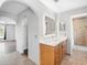 Bathroom featuring dual sinks, large mirror, and walk-in shower at 908 Stallion Way, Valrico, FL 33594
