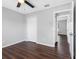 Bedroom features wood floors, ceiling fan, closet and a view of the hallway at 908 Stallion Way, Valrico, FL 33594