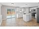 Bright kitchen featuring stainless steel appliances, center island, and sliding glass doors at 908 Stallion Way, Valrico, FL 33594