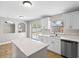 Open kitchen with stainless dishwasher, sink, and slider door to yard at 908 Stallion Way, Valrico, FL 33594
