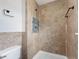 Tiled shower stall with upgraded showerhead fixtures and mosaic accents at 908 Stallion Way, Valrico, FL 33594