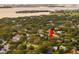 Stunning aerial view of the home nestled among lush greenery with beautiful water views at 101 Ponce De Leon Blvd, Belleair, FL 33756