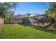 Expansive backyard with a well-maintained lawn and a lovely screened-in patio at 101 Ponce De Leon Blvd, Belleair, FL 33756