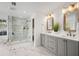 Modern bathroom with a glass shower, dual vanity, and neutral tones creating a spa-like ambiance at 101 Ponce De Leon Blvd, Belleair, FL 33756